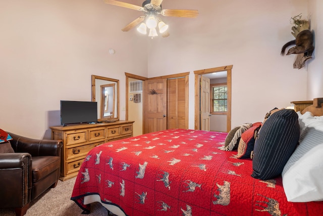 carpeted bedroom featuring a closet, a high ceiling, and ceiling fan