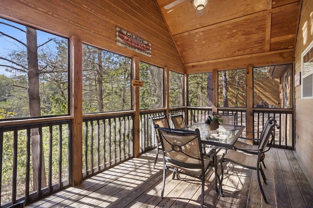 unfurnished sunroom featuring lofted ceiling and ceiling fan