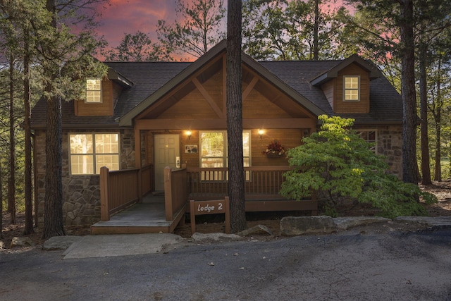 cape cod house featuring a porch