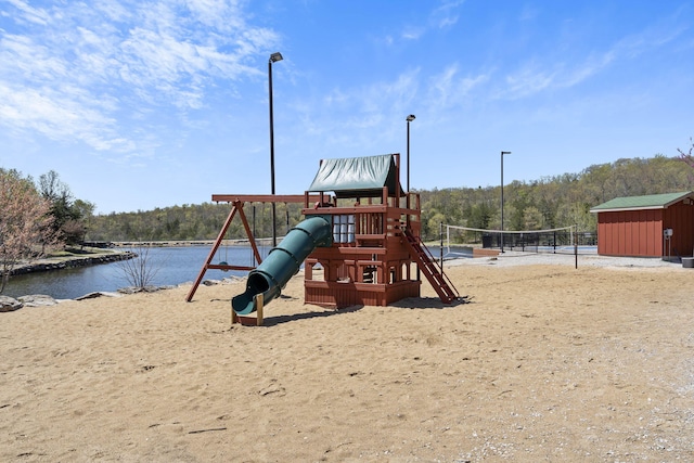 view of play area with a water view and a storage shed