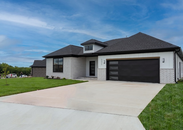 view of front of house with a front yard and a garage