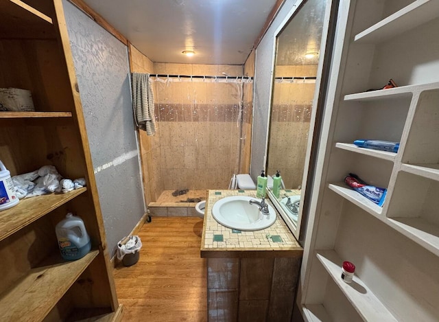 bathroom featuring vanity, walk in shower, and wood-type flooring