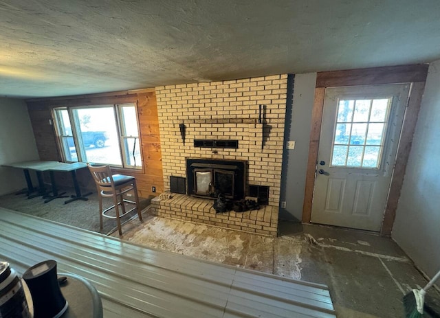 living room with a wood stove and a healthy amount of sunlight