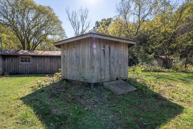 view of outbuilding with a yard