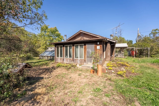 back of property with an outbuilding