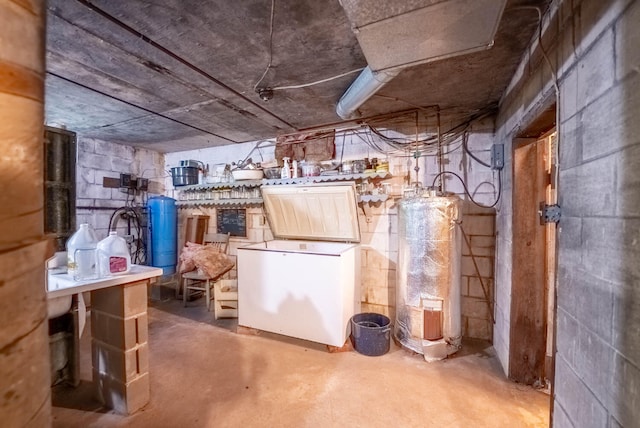 basement with water heater and white fridge