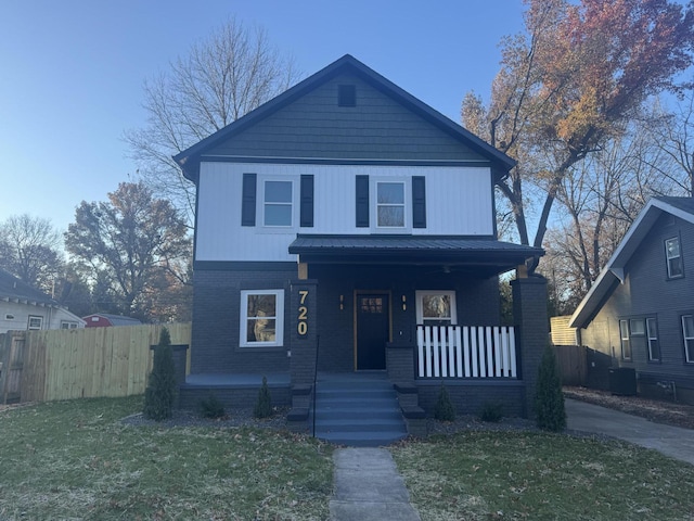 view of front facade with a front yard, a porch, and central air condition unit