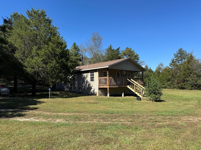 back of house featuring a yard and a wooden deck