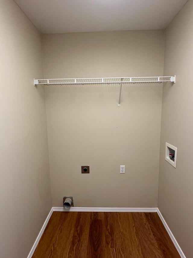 clothes washing area with hookup for an electric dryer, hookup for a washing machine, and hardwood / wood-style flooring