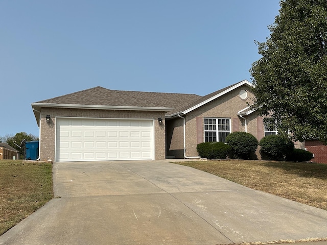 ranch-style home with a front lawn and a garage