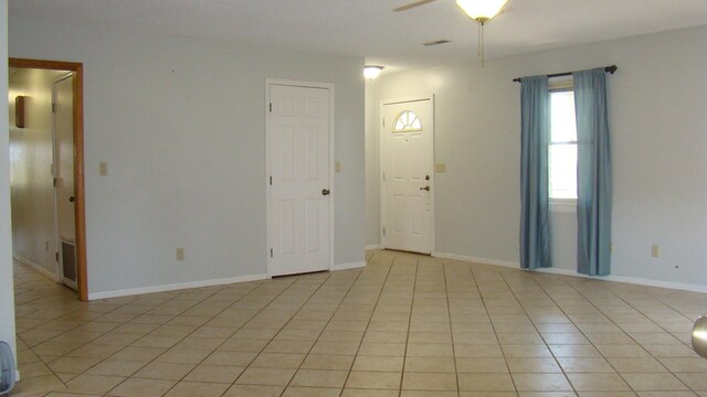 tiled foyer entrance with ceiling fan