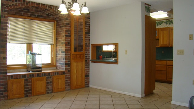 interior space featuring a notable chandelier, decorative light fixtures, and light tile patterned floors