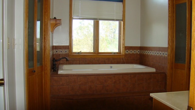 bathroom featuring tiled tub