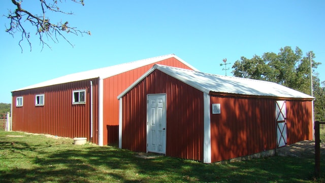 view of outbuilding featuring a lawn