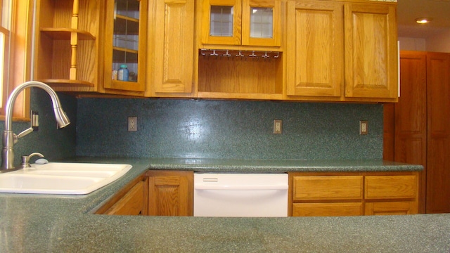 kitchen featuring dishwasher, backsplash, and sink