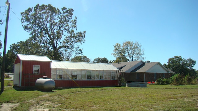 exterior space with a yard and an outbuilding