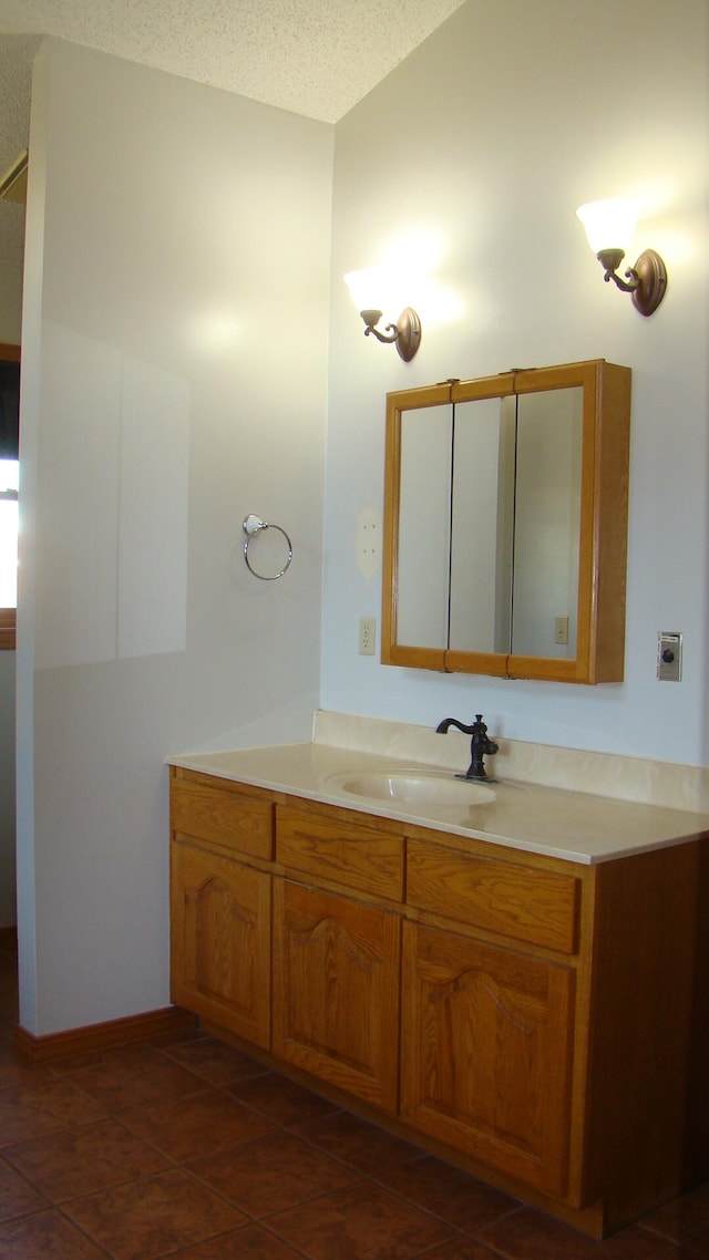 bathroom featuring vanity, a textured ceiling, and tile patterned floors