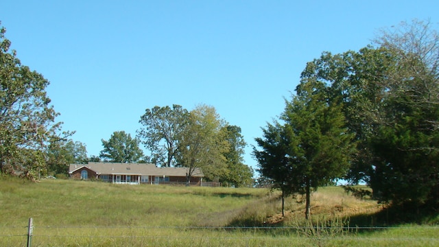 view of yard with a rural view