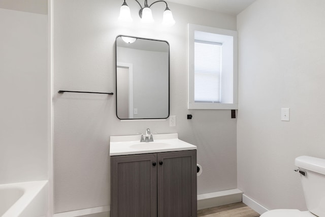 full bathroom with hardwood / wood-style flooring, vanity, toilet, and shower with separate bathtub