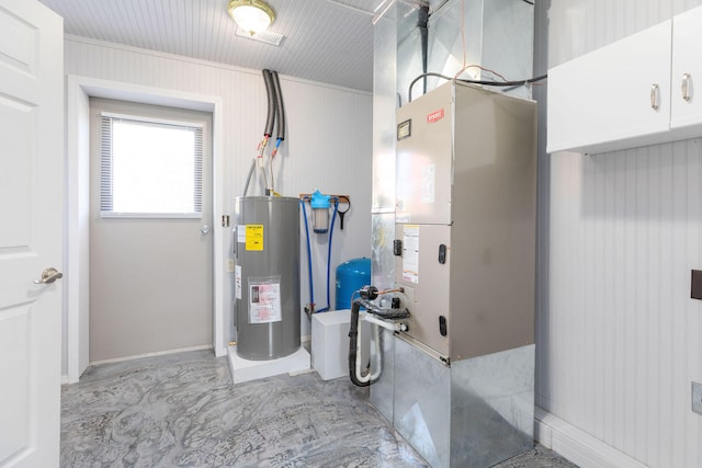 utility room featuring water heater and heating unit