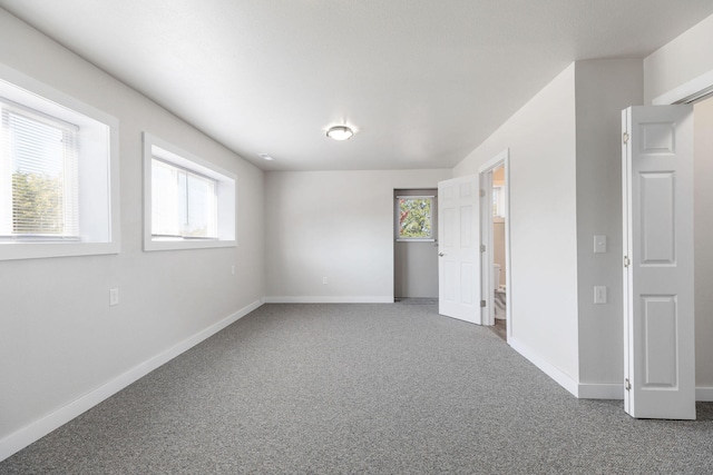 unfurnished room with carpet floors and plenty of natural light