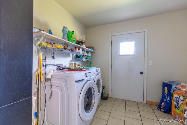 washroom with light tile patterned flooring and washer and dryer