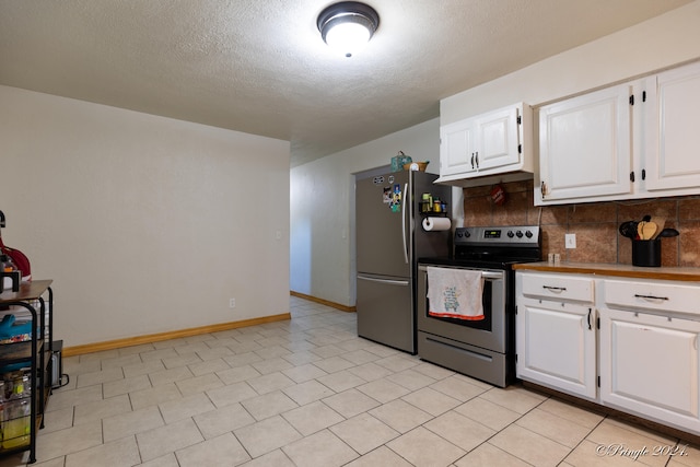 kitchen featuring decorative backsplash, white cabinets, appliances with stainless steel finishes, and a textured ceiling