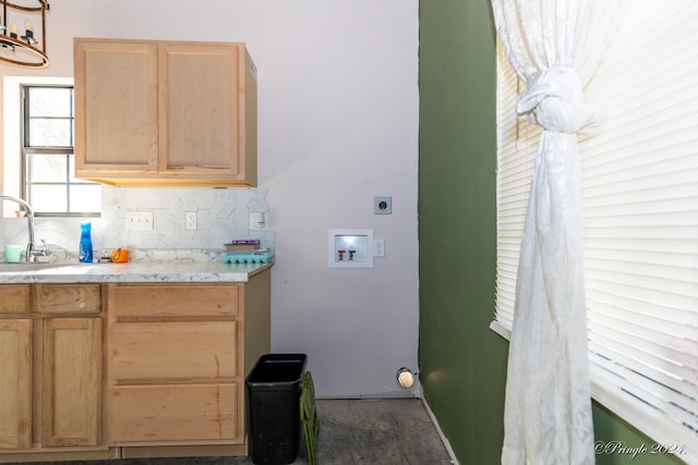 kitchen featuring sink, light brown cabinets, and backsplash