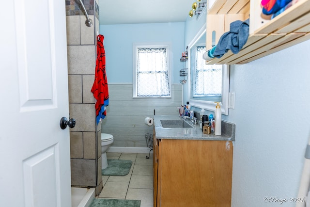 bathroom featuring vanity, tile patterned floors, curtained shower, wood walls, and toilet