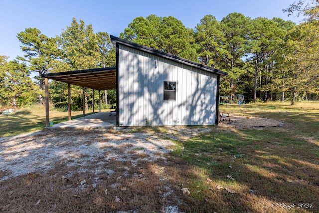 view of outdoor structure featuring a yard and a carport