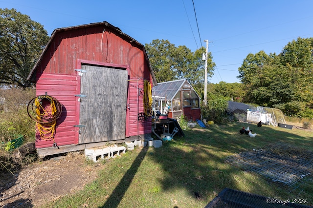 view of outbuilding with a lawn