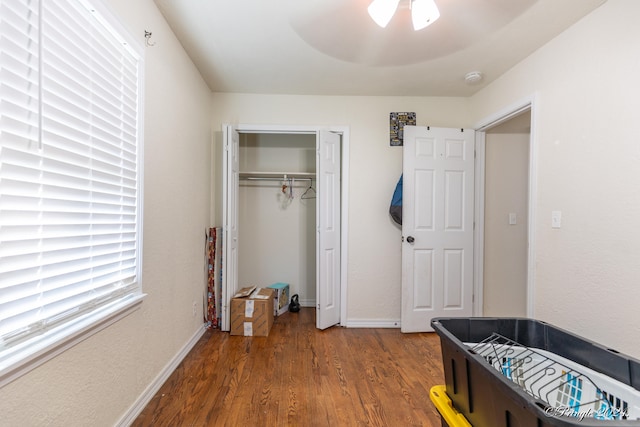 bedroom with a closet, hardwood / wood-style floors, and ceiling fan