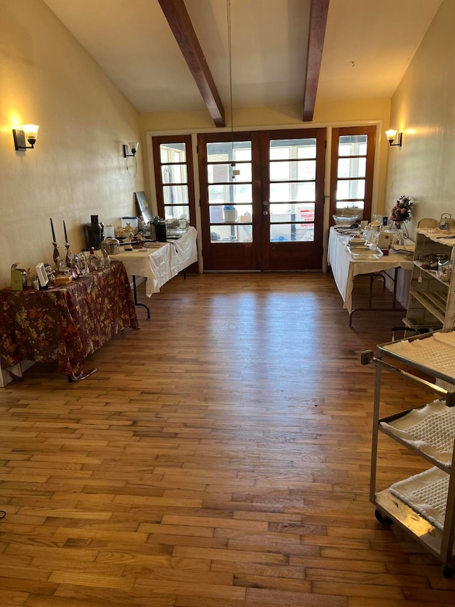 interior space with french doors, vaulted ceiling with beams, and dark hardwood / wood-style flooring