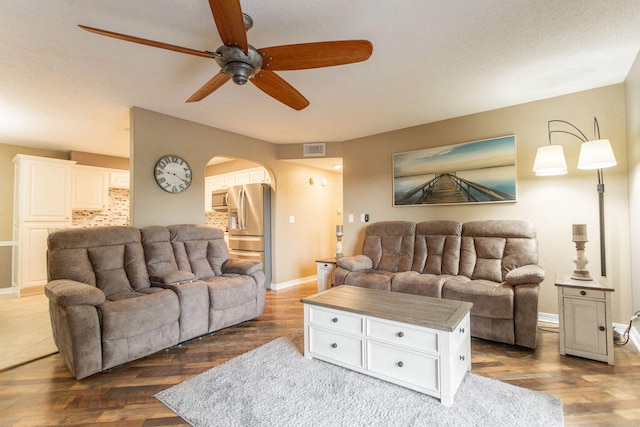 living room with ceiling fan and hardwood / wood-style flooring