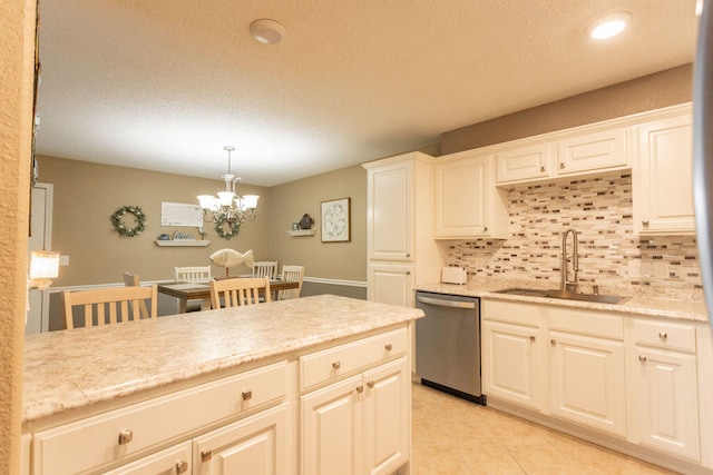 kitchen featuring decorative backsplash, sink, an inviting chandelier, decorative light fixtures, and dishwasher