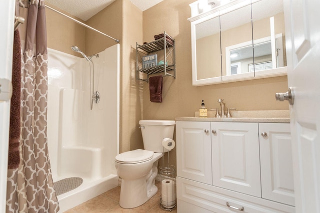 bathroom with tile patterned flooring, toilet, curtained shower, vanity, and a textured ceiling