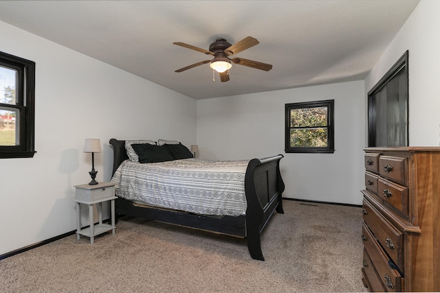 bedroom featuring light colored carpet and ceiling fan