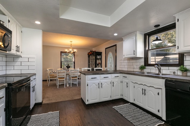 kitchen featuring kitchen peninsula, black appliances, sink, and white cabinets