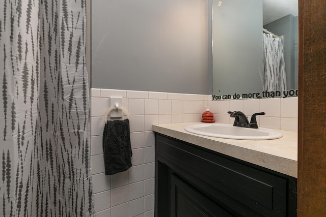 bathroom featuring tile walls and vanity