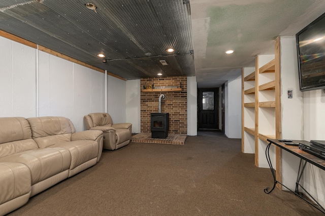 living room with carpet flooring and a wood stove