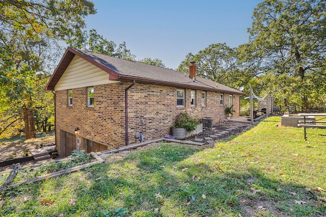 view of home's exterior with a garage and a lawn