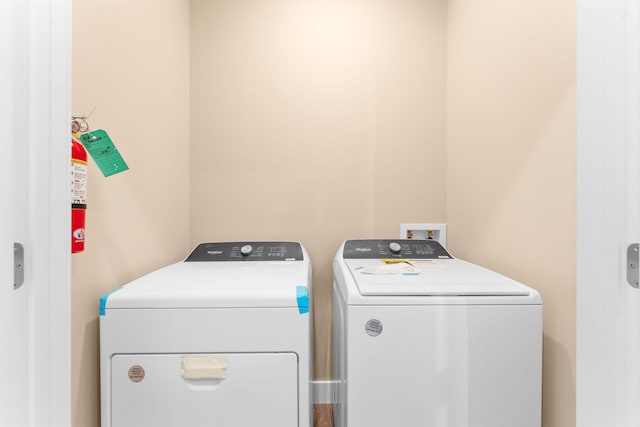 clothes washing area with independent washer and dryer