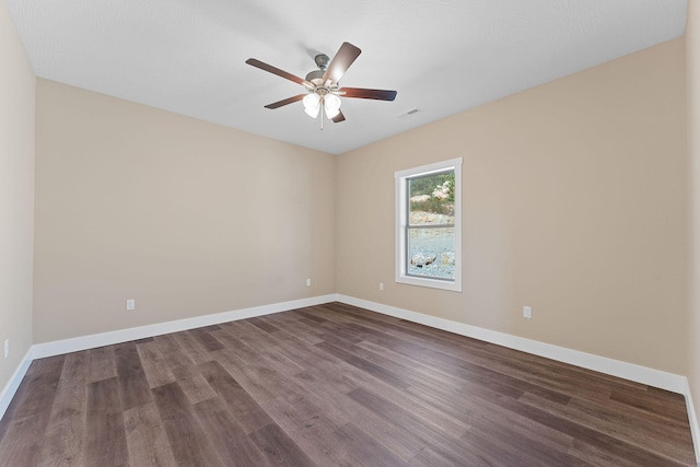 unfurnished room with ceiling fan and dark hardwood / wood-style floors