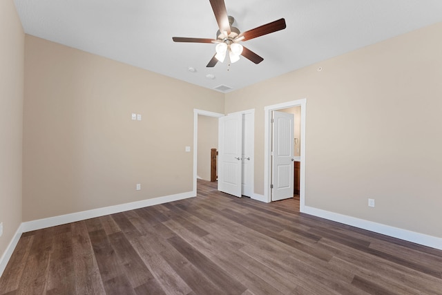 unfurnished bedroom featuring dark hardwood / wood-style floors and ceiling fan