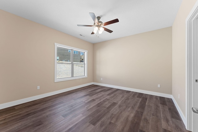 empty room with ceiling fan and dark wood-type flooring