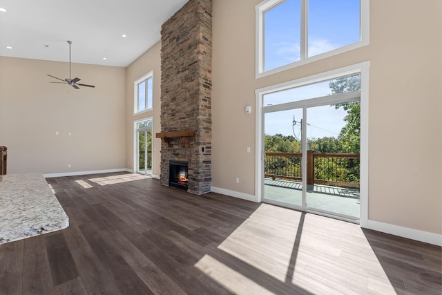 unfurnished living room with a towering ceiling and a healthy amount of sunlight