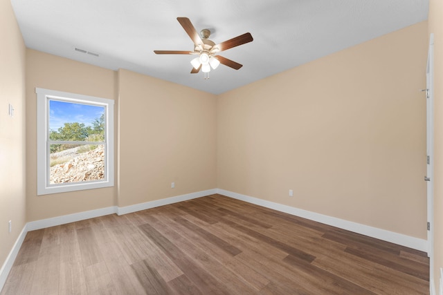 spare room with hardwood / wood-style flooring and ceiling fan