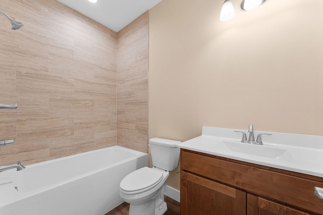 full bathroom with tiled shower / bath combo, vanity, and toilet