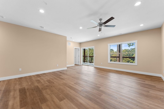 spare room with light wood-type flooring and ceiling fan