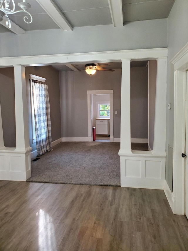 unfurnished room featuring ornate columns, hardwood / wood-style flooring, and ceiling fan